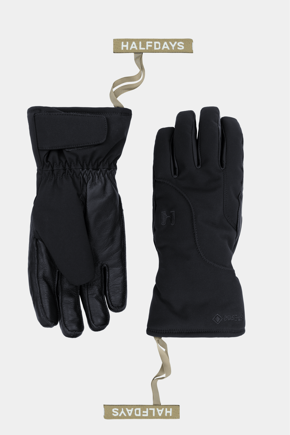 A pair of black outdoor gloves shown flat against a light gray background, one glove facing palm side and the other showing the back. Each glove is attached to a beige wire hanger with a tan label reading HALFDAYS.