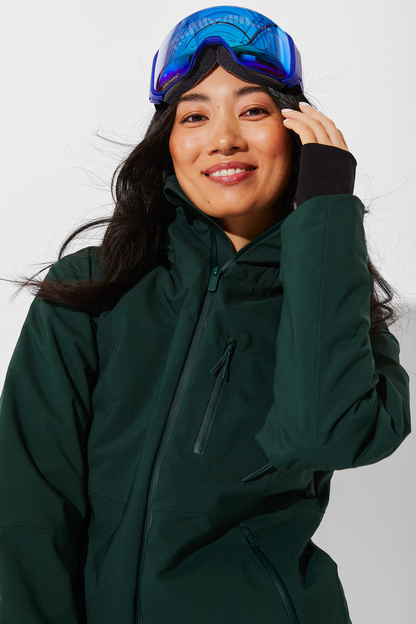 Woman wearing Alpine Green ski jacket