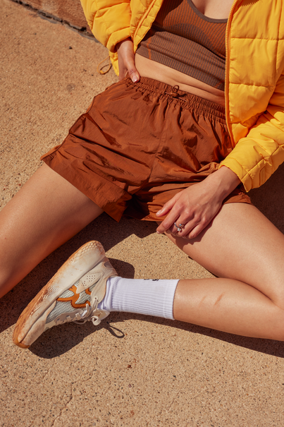 Woman Wearing Caramel Colored Nylon Shorts