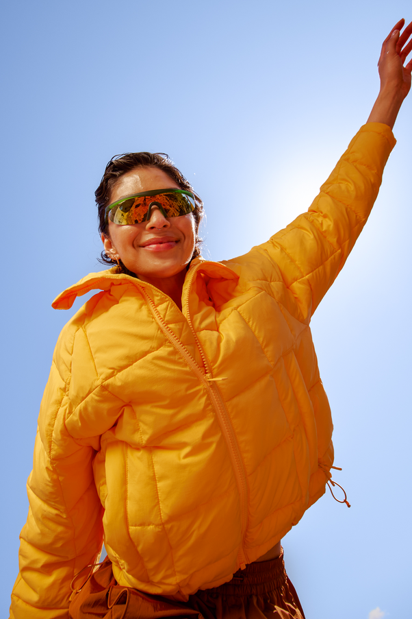 Woman Wearing Creamsicle Nellie Packable Puffer