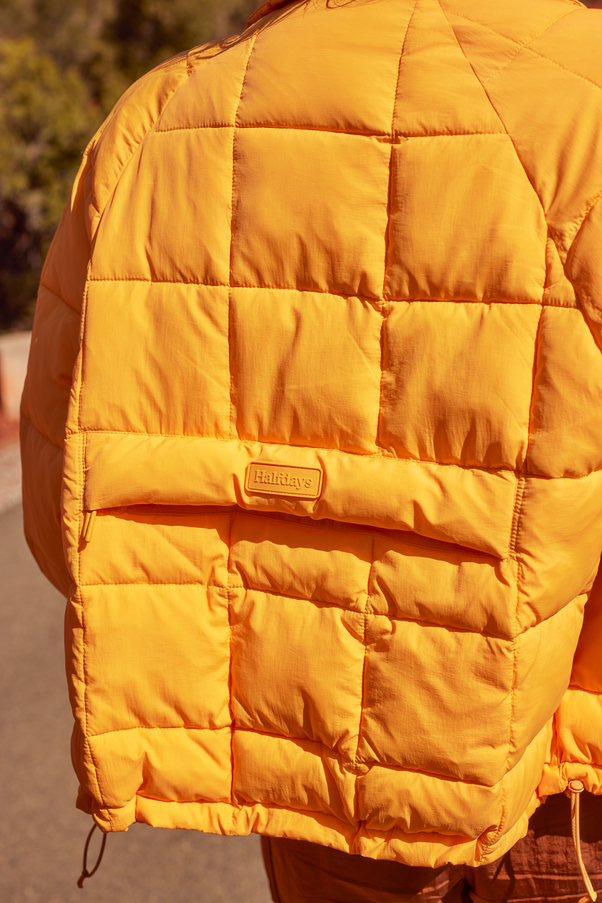 Woman Wearing Creamsicle Nellie Packable Puffer