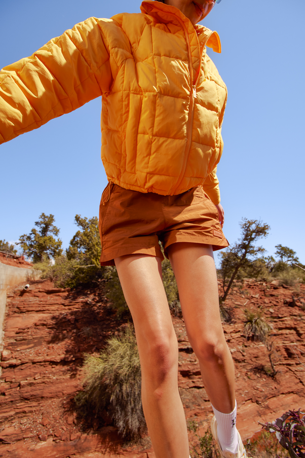 Woman Wearing Creamsicle Nellie Packable Puffer