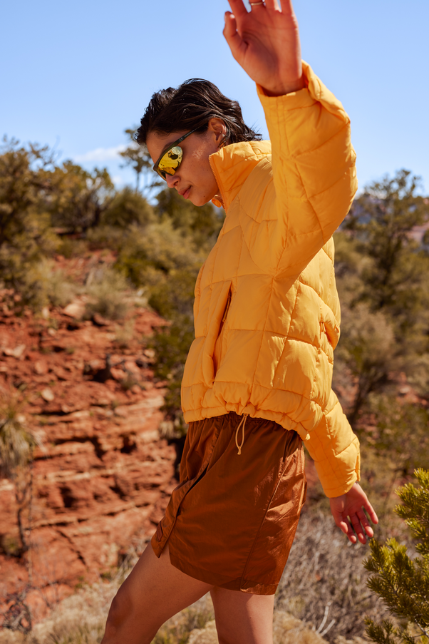 Woman Wearing Creamsicle Nellie Packable Puffer