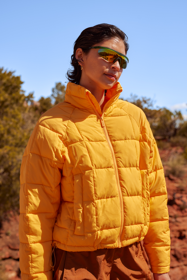 Woman Wearing Creamsicle Nellie Packable Puffer